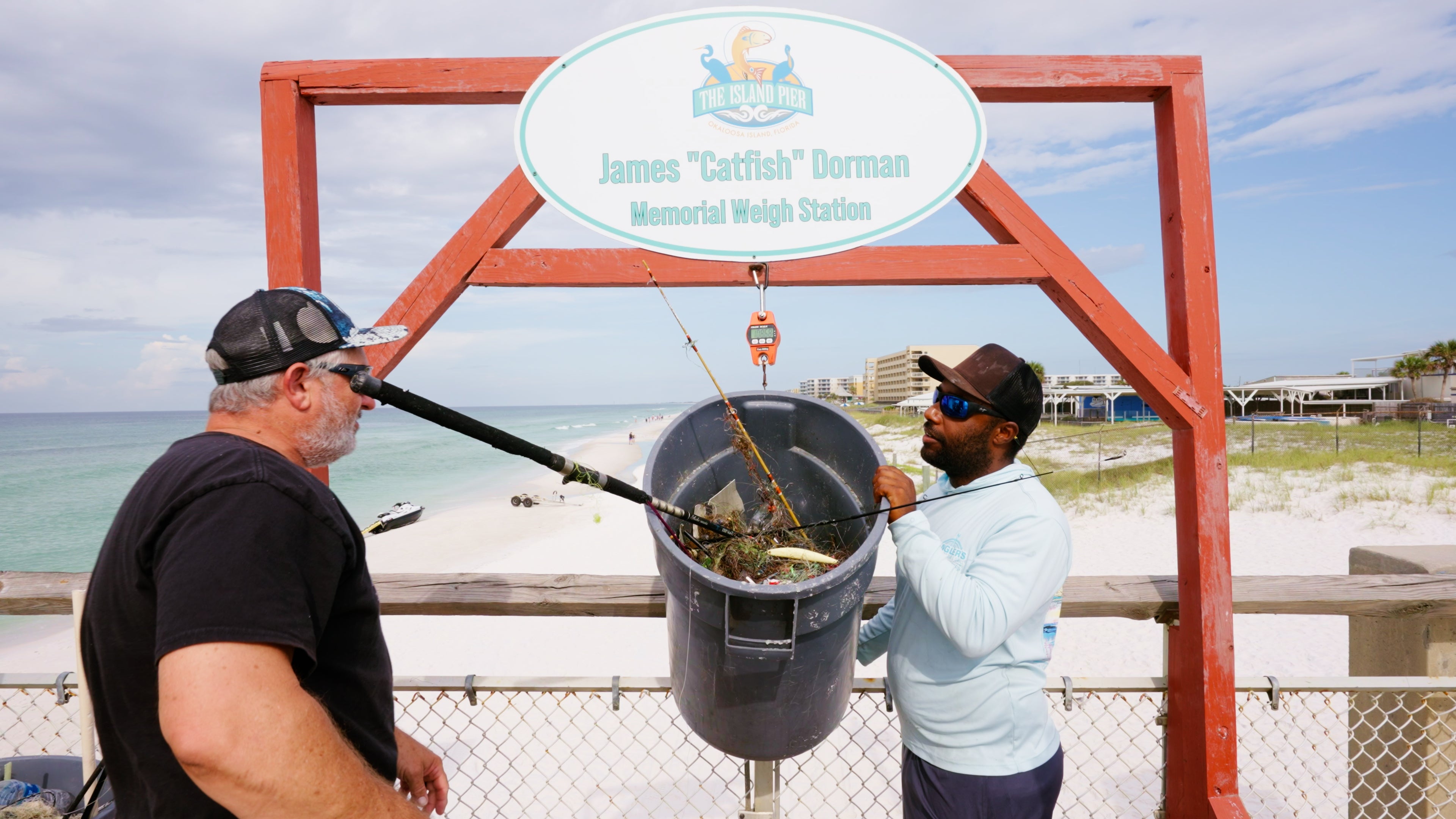 weighing trash taken from ocean at Okaloosa pier cleanup dive