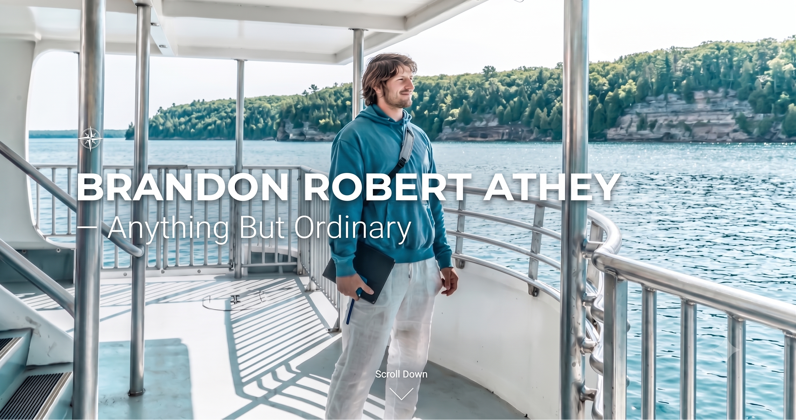 A man stands on the deck of a boat overlooking a lake and forested shoreline, wearing a teal hoodie, white sweatpants, and holding a black tablet. Large overlaid text reads 'BRANDON ROBERT ATHEY — Anything But Ordinary' with a small 'Scroll Down' link near the bottom.